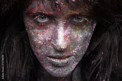 girl in paint and neon powder with glitter