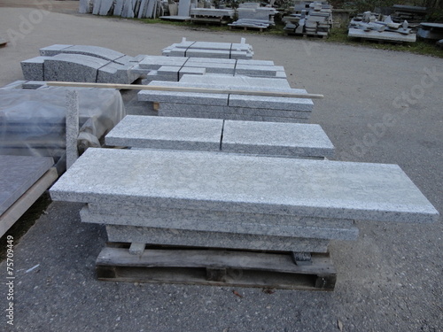 Stacks of granite slabs in a yard