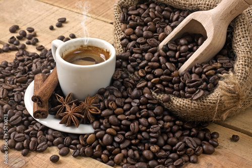 coffee cup and grains on wooden table