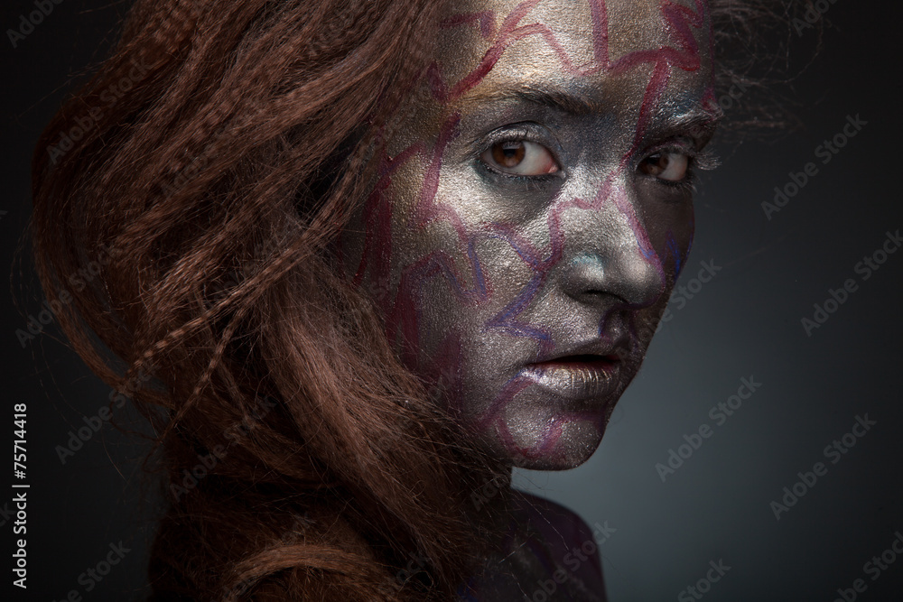 Beautyful girl with silver and violet glitter on her face