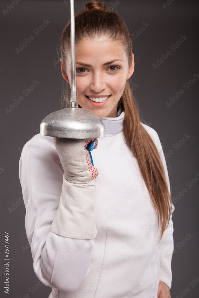 Smiling girl in white fencing costume. with sword Smiling girl in white fencing costume. with sword