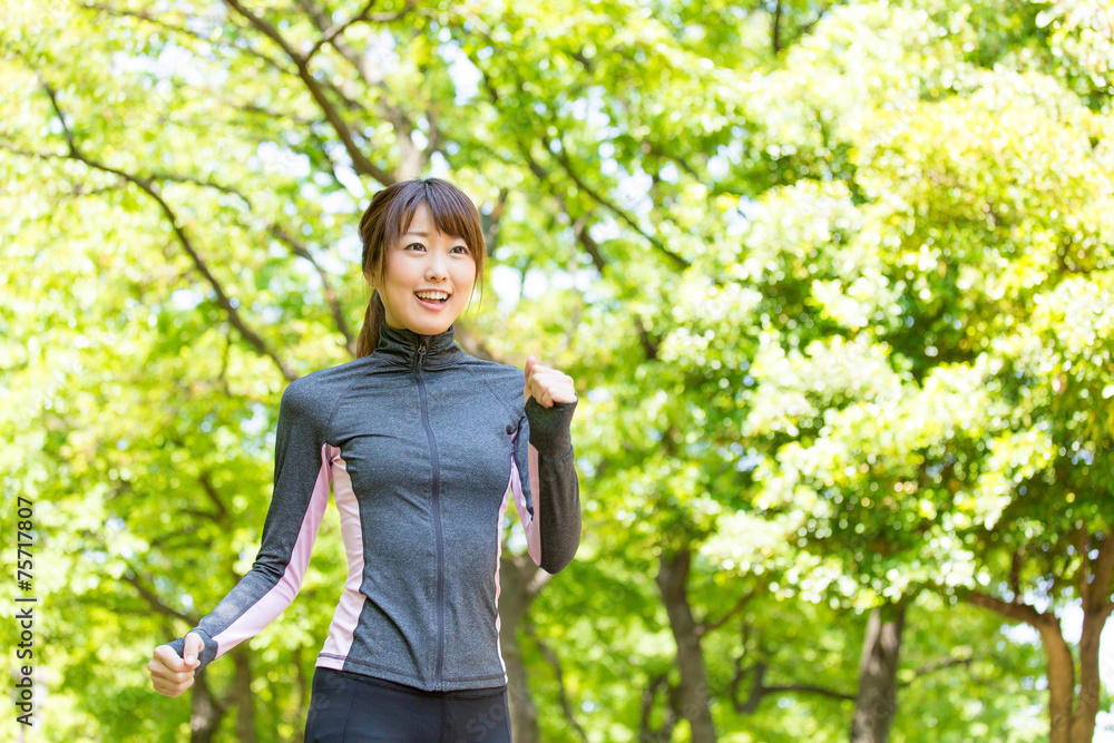 young asian woman running in the park young asian woman running in the park