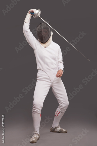 girl in white fencing costume. with sword and fencing mask 