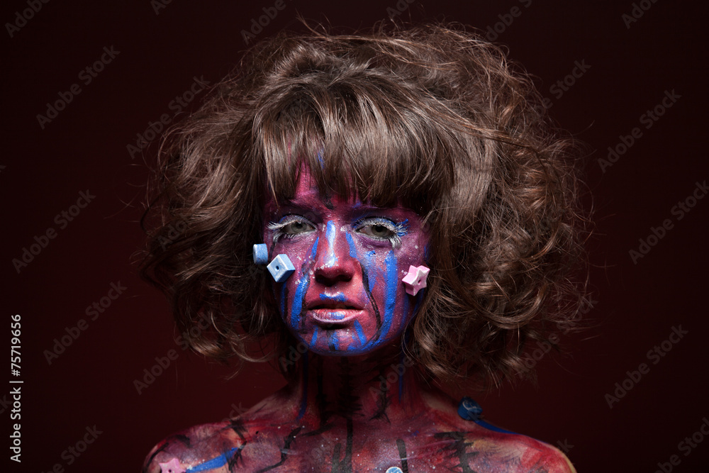 Beautiful face of a woman covered in paint