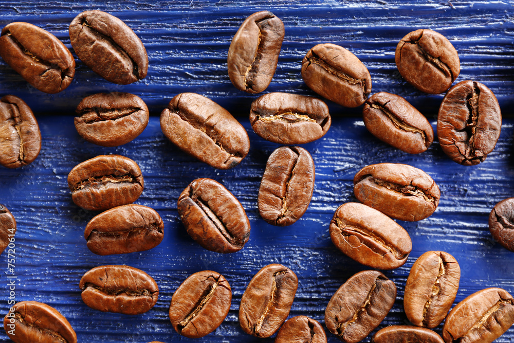 Coffee beans on wooden background, close-up