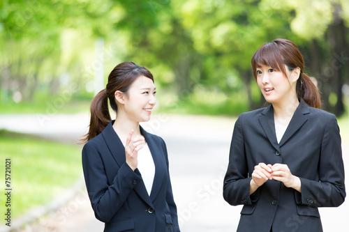 asian businesswomen talking in the park