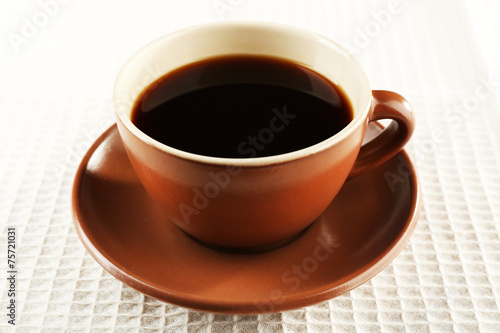 Cup of coffee on white napkin background