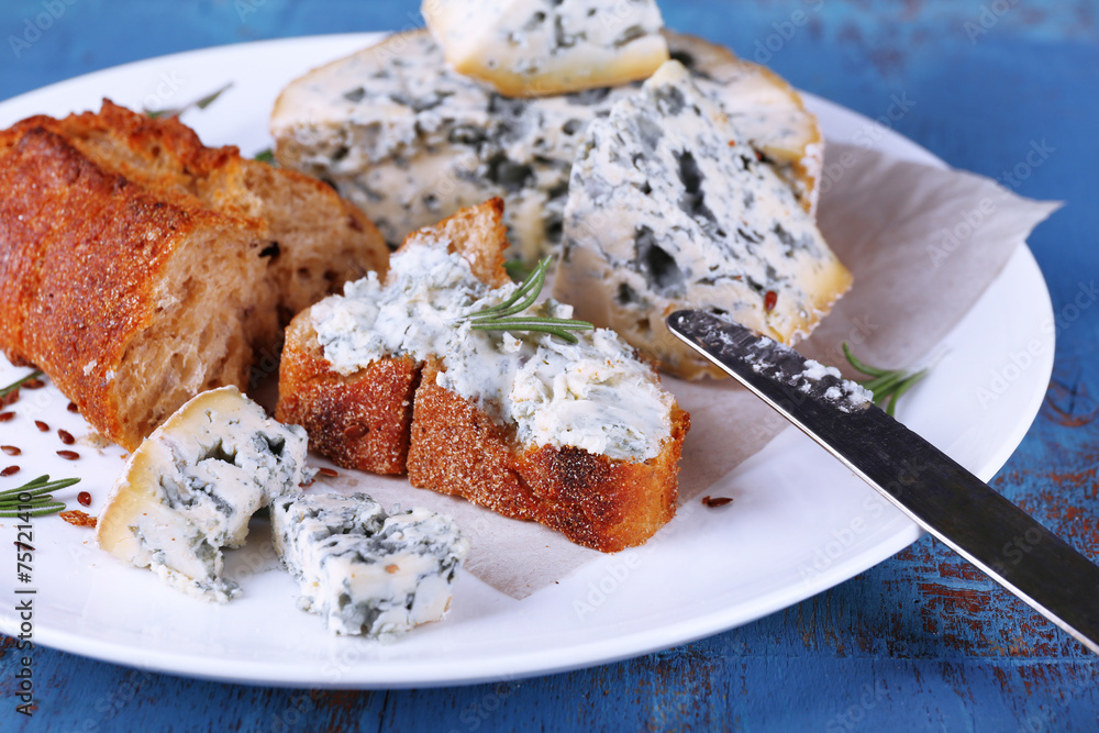 Blue cheese with sprigs of rosemary, bread and nuts Blue cheese with sprigs of rosemary, bread and nuts