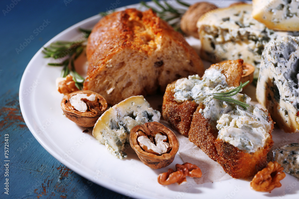 Blue cheese with sprigs of rosemary, bread and nuts