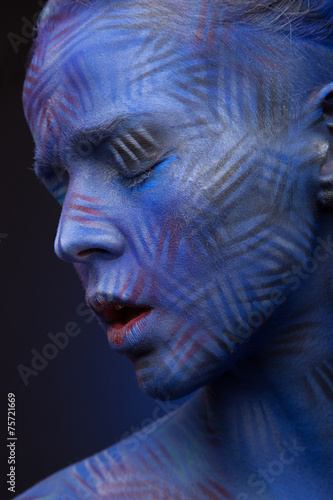 art photo of a beautiful woman with blue face