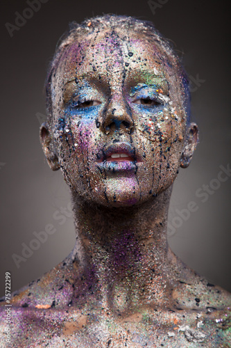 Beautiful face of a woman covered in glitter. Face art. Sexy