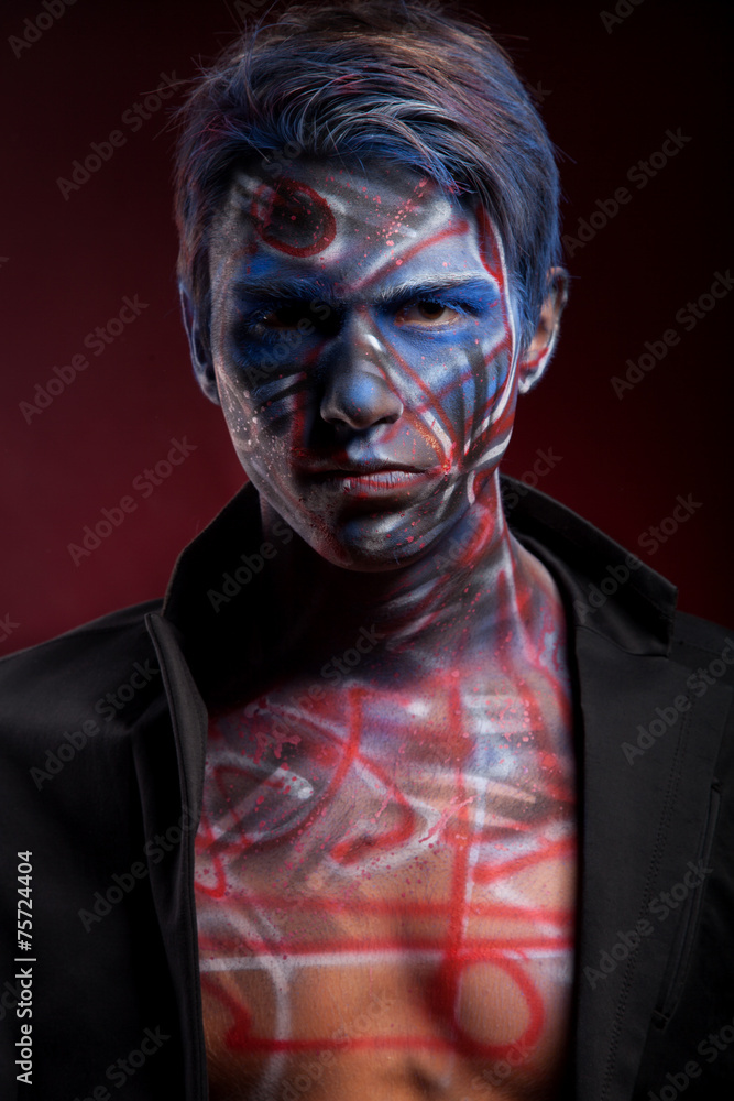 A creepy portrait of a man with bloody body art and face art A creepy portrait of a man with bloody body art and face art