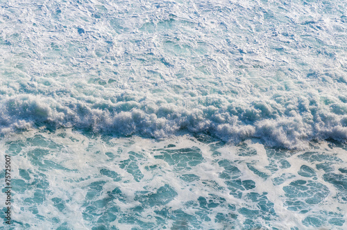 Blue sea with waves and foam
