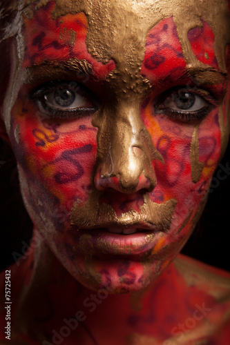 young woman with creative face-art and flow paint.