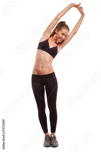 Young beautiful fitness girl doing streching exercise. isolated 