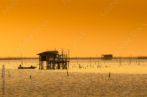 silhouette of thai fishing house at sunset