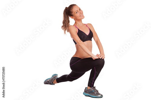 Fototapeta Naklejka Na Ścianę i Meble -  Young beautiful fitness girl doing streching exercise. isolated 