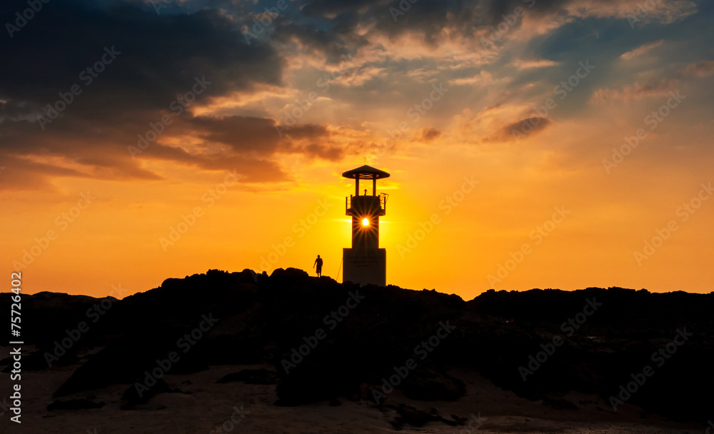 Silhouette of lighthouse at sunset off the coast, thailand