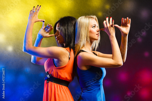 Women in evening dresses dancing in the club