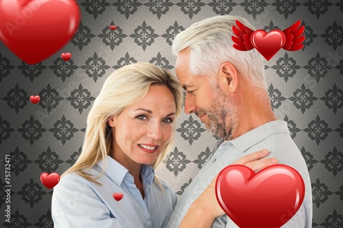 Composite image of happy couple standing and smiling at camera