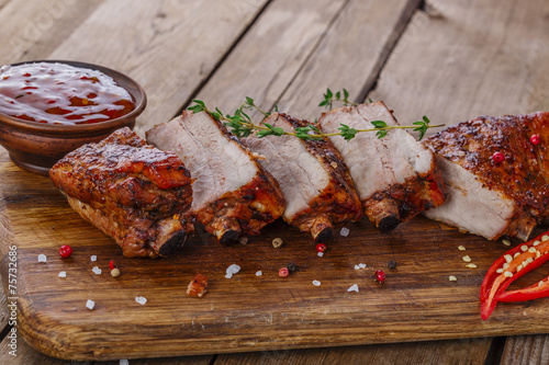 baked pork ribs on a wooden board