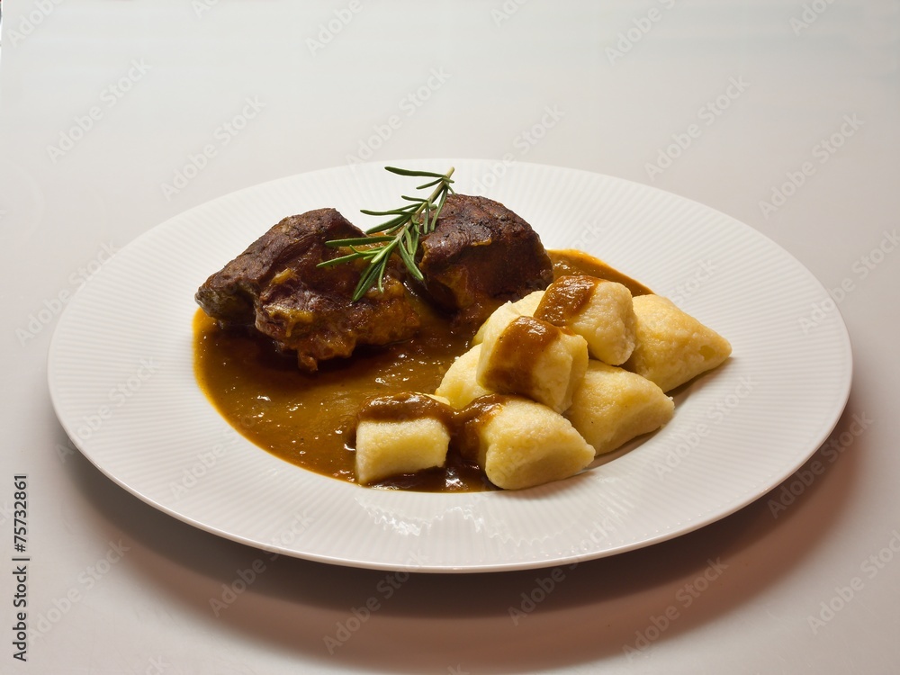 Roasted wild game in ginger bread sauce with potato dumplings Roasted wild game in ginger bread sauce with potato dumplings
