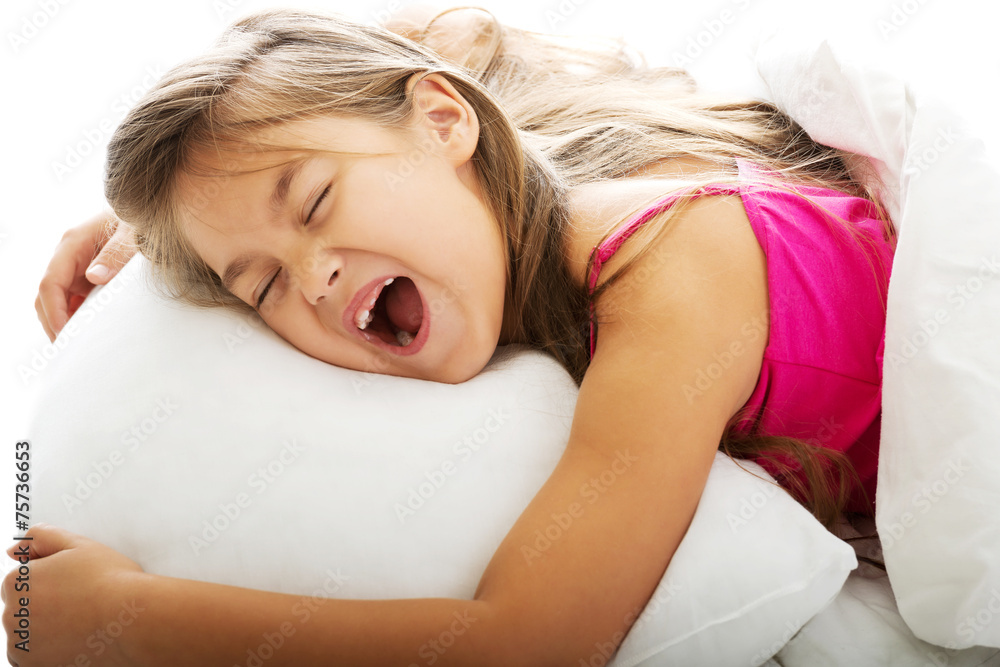 Young girl yawning while waking up Young girl yawning while waking up