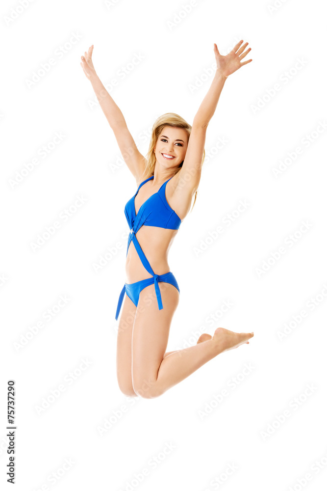 Jumping woman with hands up