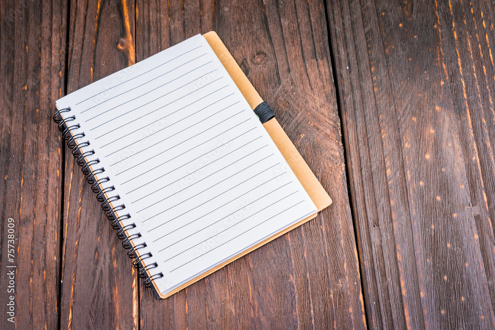 Note book on wooden background Note book on wooden background
