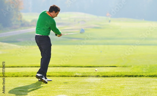 Golfer swing, teeing off on beautiful summer morning