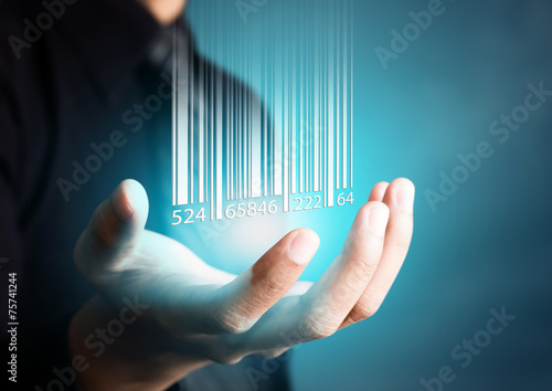 Barcode dropping on businessman hand, financial concept photo
