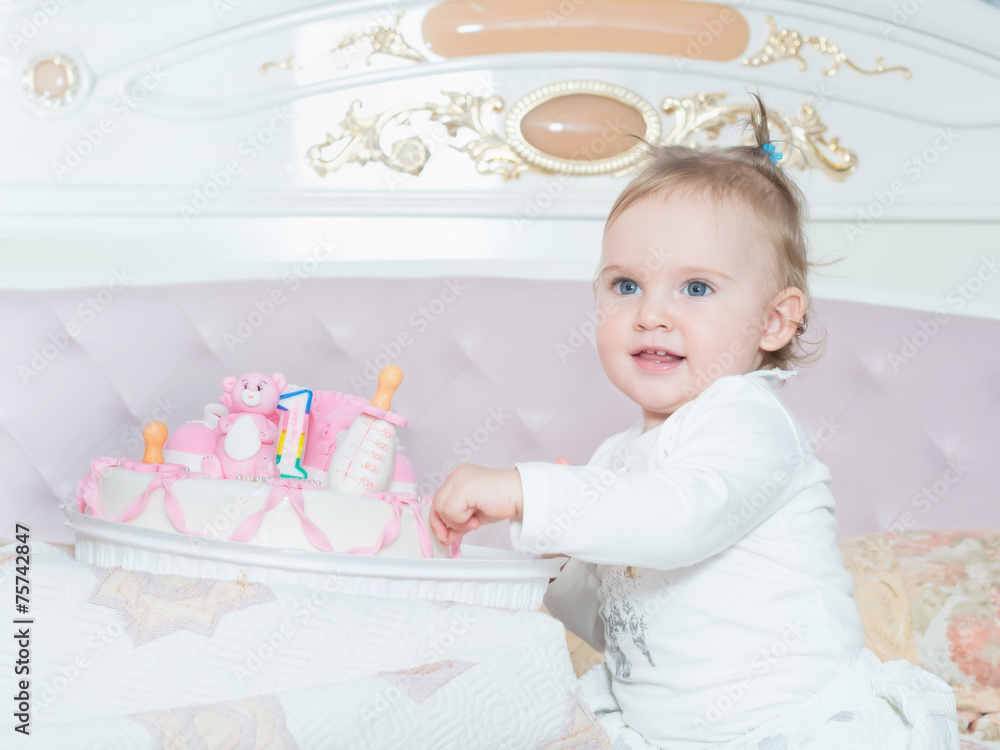 Small caucasian child girl on happy birthday with cake at home