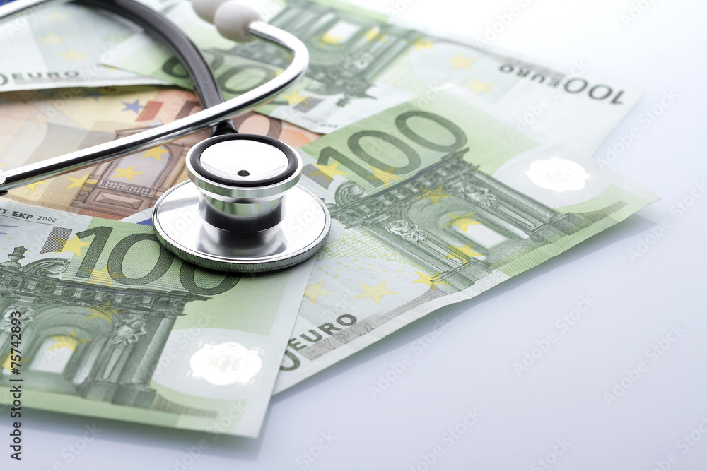 Black stethoscope close-up on top of euro banknotes side view Black stethoscope close-up on top of euro banknotes side view