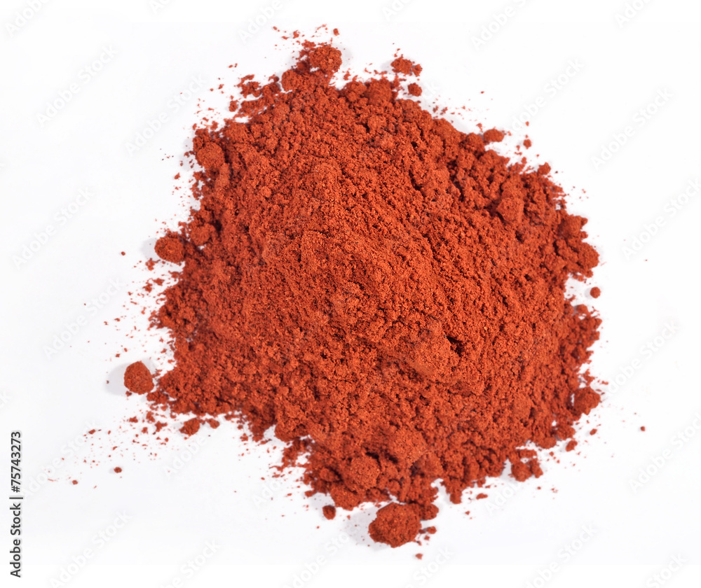 Heap of ground paprika on a white Heap of ground paprika on a white