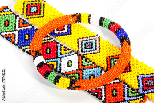 Circular Beaded Zulu Armband Atop Two Wristbands photo