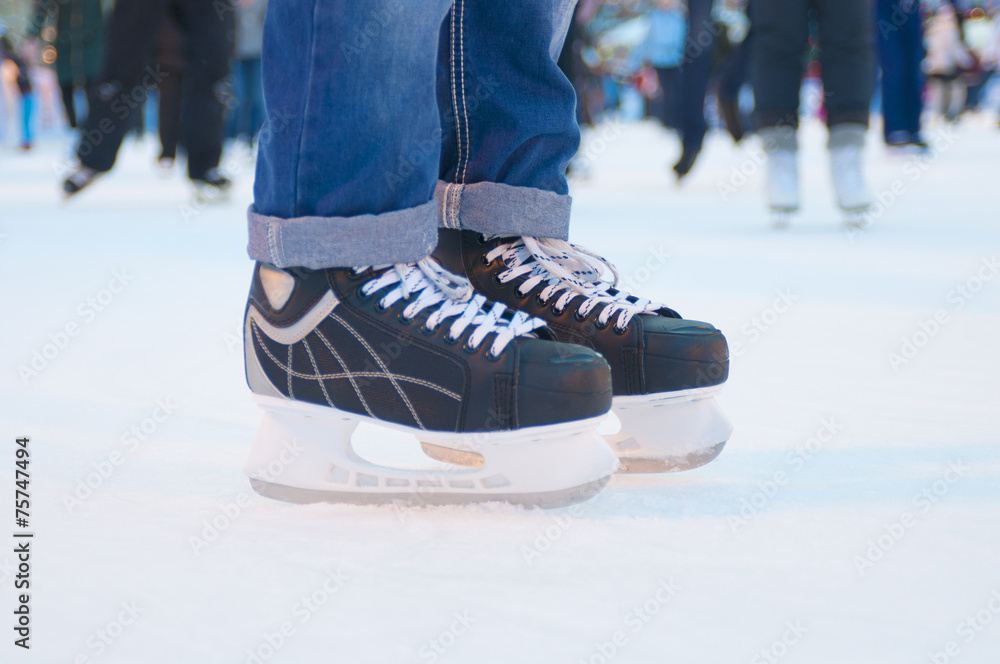 Legs of skater on winter ice rink Legs of skater on winter ice rink