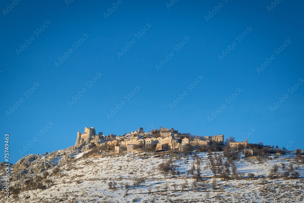 Panoramic view of Rocca Calascio in winter time with blue sky. A