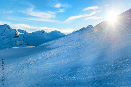 Snowy blue mountains in clouds