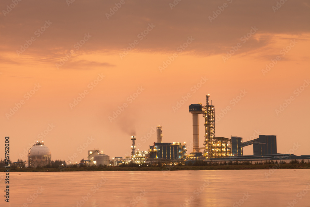 Sunset time of Oil refinery with reflection, petrochemical plant