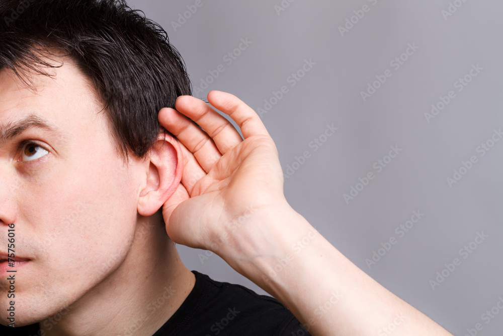 Portrait of young casual man which overhears conversation Portrait of young casual man which overhears conversation