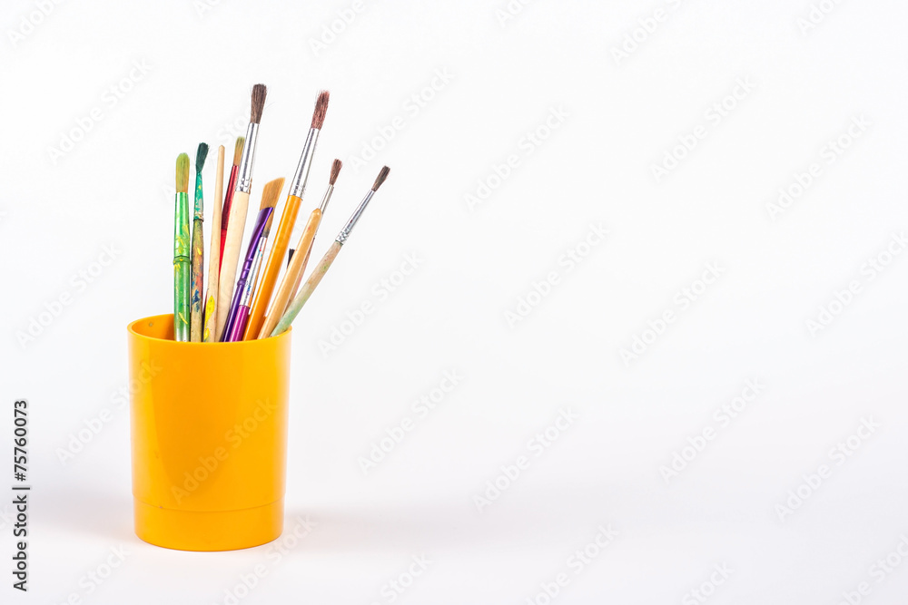 isolated paints brushes in plastic beaker isolated paints brushes in plastic beaker