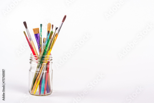 isolated paints brushes in a glass