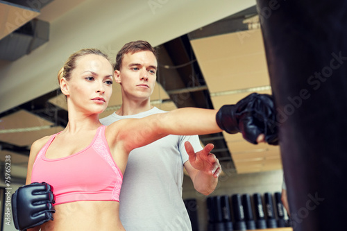 woman with personal trainer boxing in gym © Syda Productions