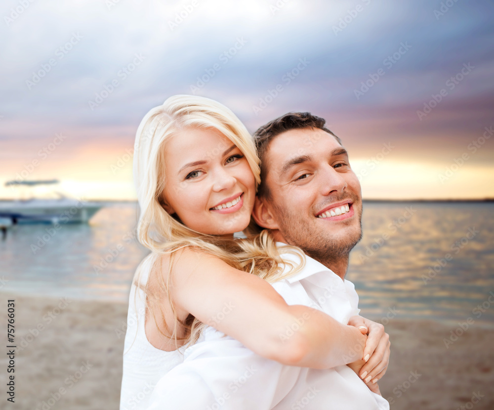 couple having fun and hugging on beach