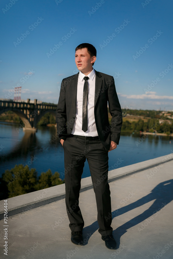 business man in a blue shirt against the blue sky business man in a blue shirt against the blue sky