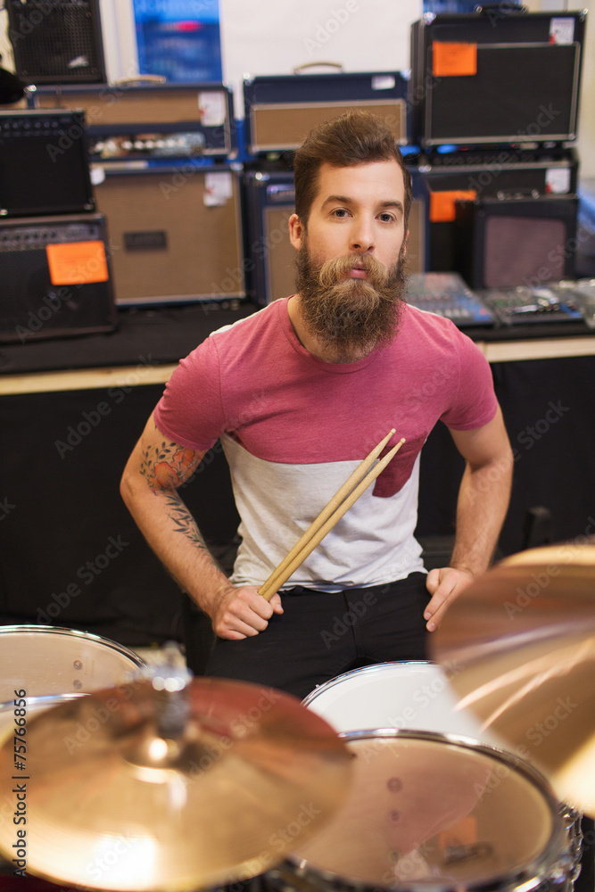 Obraz premium male musician playing cymbals at music store