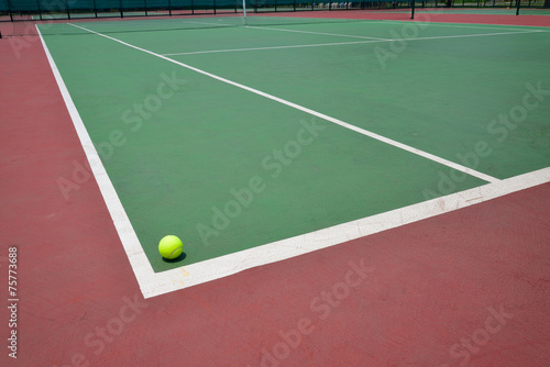 tennis ball on green court © sutichak
