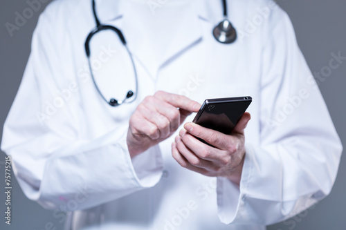 Doctor hands using mobile phone