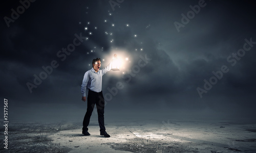 Businessman in search in darkness