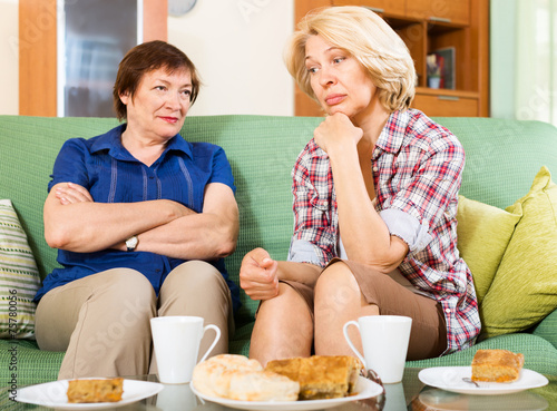Fotografija sad mature women  discussing problems
